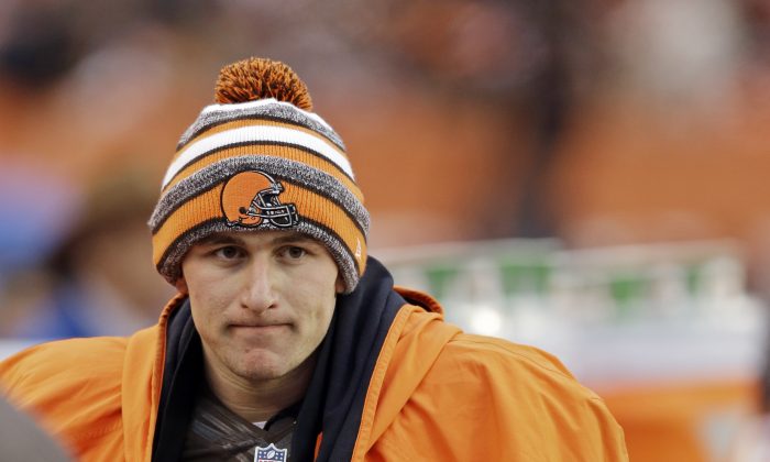 Cleveland Browns quarterback Johnny Manziel watches from the sidelines in the fourth quarter of an NFL football game against the Cincinnati Bengals Sunday, Dec. 14, 2014, in Cleveland. (AP Photo/Tony Dejak)