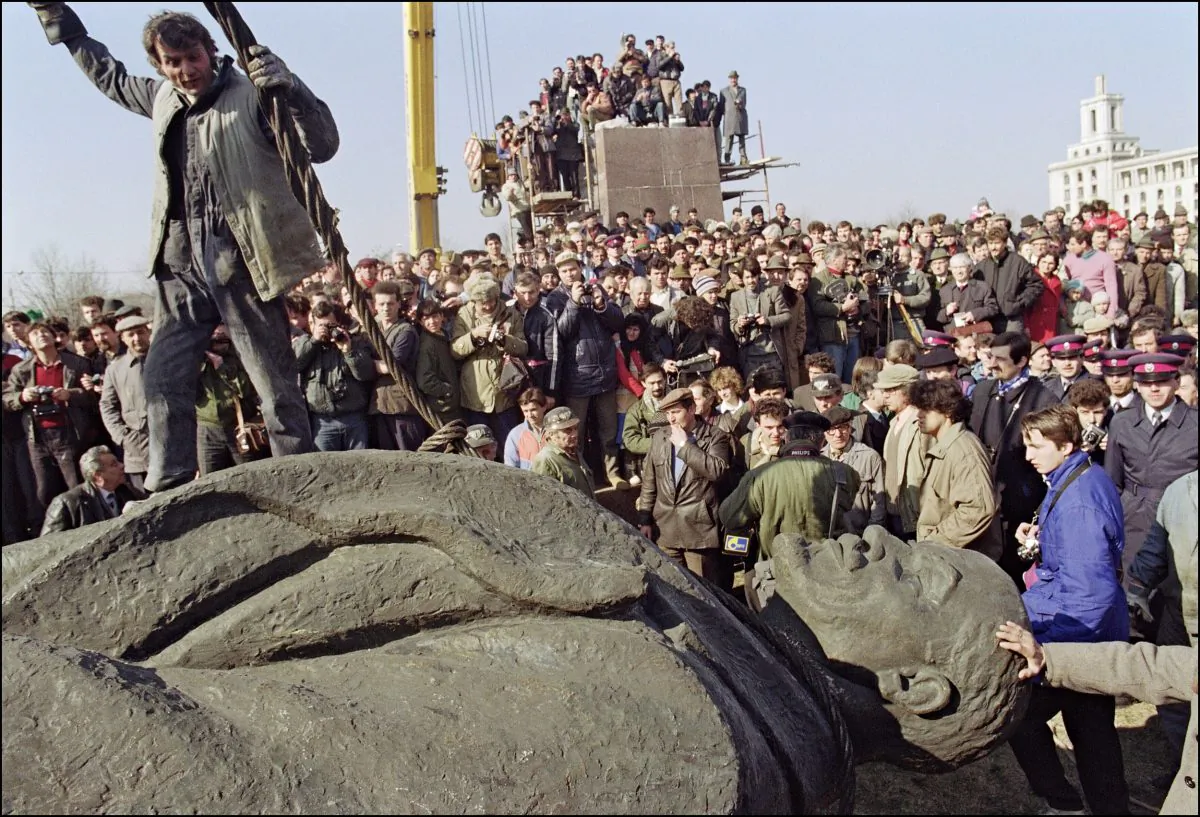 A Romanian worker stands atop the statue, sculptured in a pure style of socialist realism, of Russian Bolshevik revolutionary leader Vladimir Ilyich Lenin after it was removed from its pedestal on March 5, 1990, in Bucharest. Romanian communist dictator Nicolae Ceausescu and his wife Elena were executed by firing squad on Dec. 25, 1989, in Bucharest after being found guilty by an army tribunal of 'crimes against the people'. (Andre Durand/AFP/Getty Images)