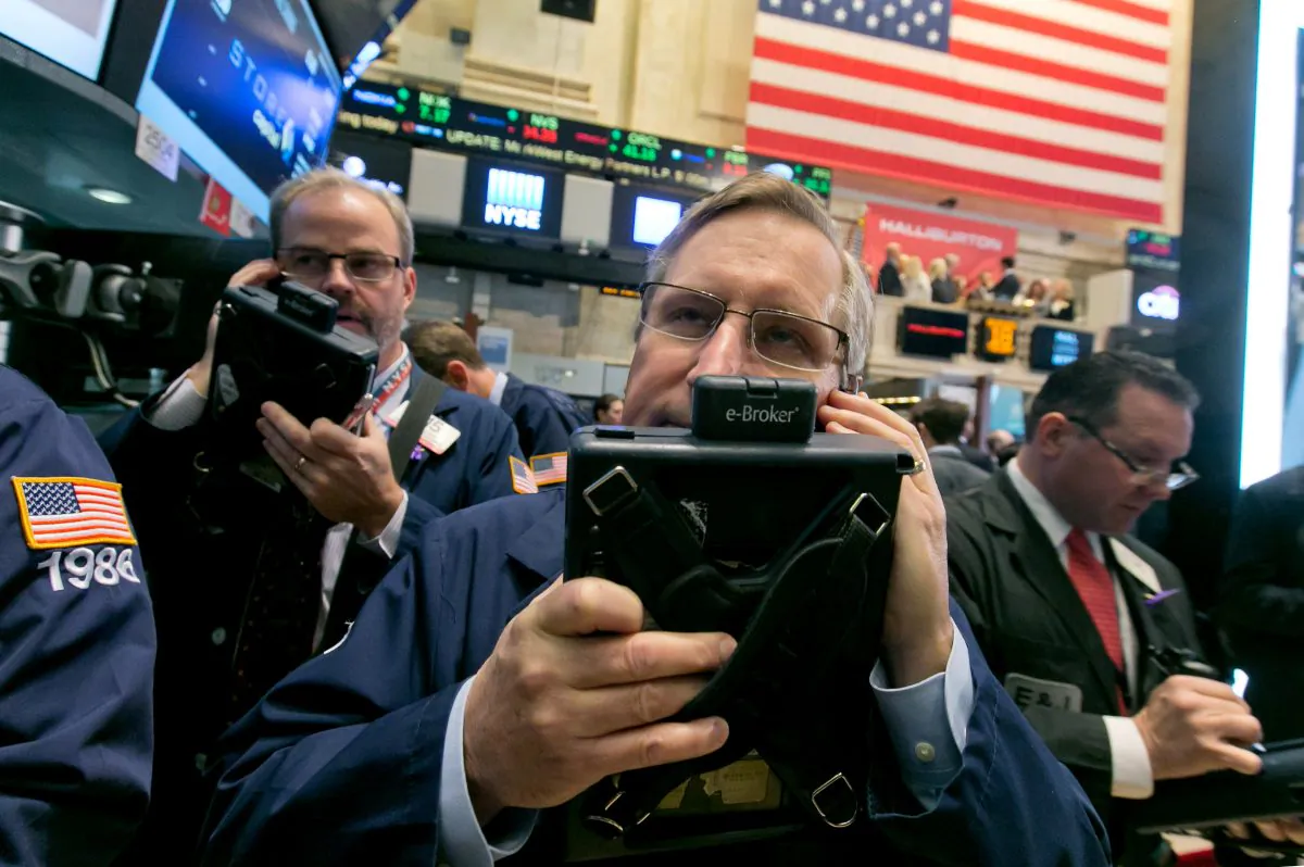 Traders David O'Day (L) and Christopher Fuchs work on the floor of the New York Stock Exchange on Nov. 18, 2014. (AP Photo/Richard Drew)