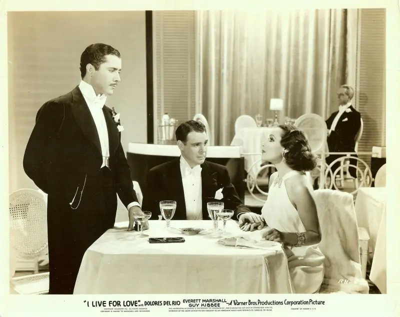 Dolores del Rio with Don Alvarado and Everett Marshall (sitting) I Live for Love, 1935. Dolores del Rio wears an Orry-Kelly gown. (Wikimedia Commons)