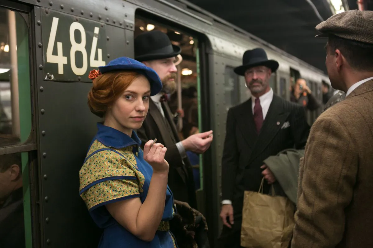 People donning early- and mid-20th century fashion stand in the doorway of a vintage MTA subway train, which only runs during the holidays, in Manhattan on Dec. 14, 2014. The event includes live jazz bands and dancing. (Benjamin Chasteen/Epoch Times)