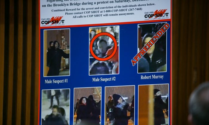 A reward poster for suspects accused of assaulting two police lieutenants during recent protests in New York. (Benjamin Chasteen/Epoch Times)