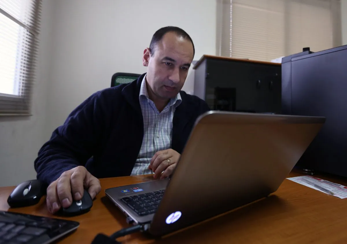 Lebanese Bahaa Nasr of Cyber Arabs checks his email from his office in Beirut, Lebanon, on Dec. 17, 2014. Cyber Arabs is an online safety project run by the London-based Institute for War and Peace Reporting and Nasr is among those who recently helped uncover a botched cyberattack suspected of having been carried out by the Islamic State group. (AP Photo/Bilal Hussein)