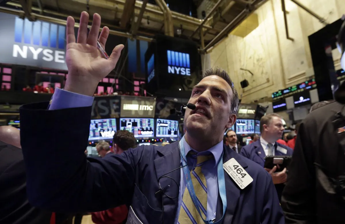 Trader Gregory Rowe works on the floor of the New York Stock Exchange Thursday, Dec. 11, 2014. (AP Photo/Richard Drew)