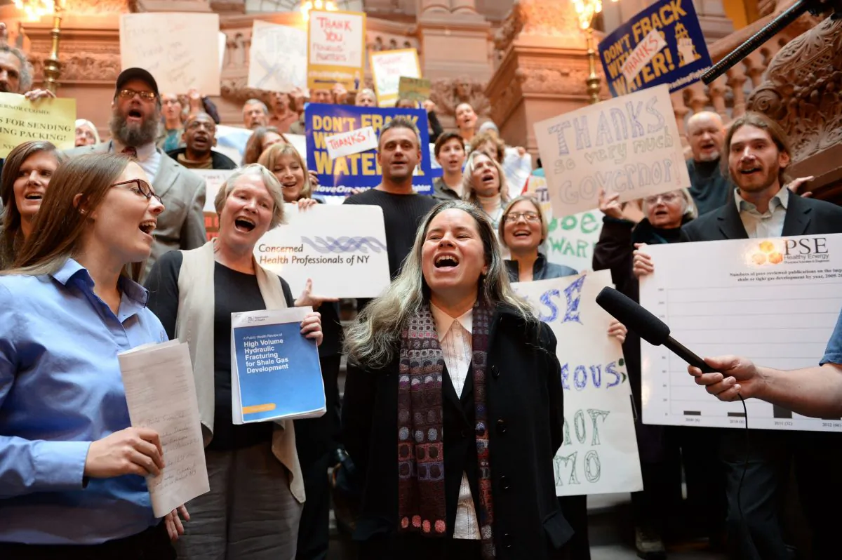 Singer Natalie Merchant leads a group of anti-fracking activists in a rendition of Pete Seeger's "This Land is Our Land" during an event at the New York State Capitol building in Albany, N.Y., on Thursday, to thank Gov. Andrew Cuomo for the ban on high-volume hydraulic fracturing. (AP Photo/The Daily Gazette, Patrick Dodson)