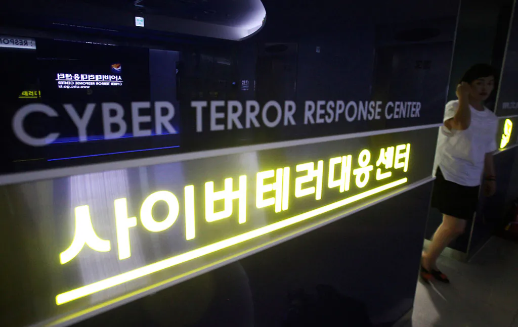 A woman walks by a sign at Cyber Terror Response Center of National Police Agency in Seoul, South Korea, on July 16, 2013. Most North Koreans have never even seen the Internet. But the country Washington suspects is behind a devastating hack on Sony Pictures Entertainment has managed to orchestrate a string of crippling cyber infiltrations of South Korean computer systems in recent years, officials in Seoul believe, despite North Korea protesting innocence. (AP Photo/Ahn Young-joon)