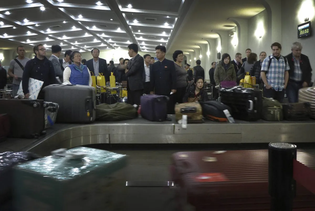 FILE - In this Oct. 21, 2014 file photo, passengers wait for their luggage upon arrival at the Sunan International Airport in Pyongyang, North Korea before closing its door for foreign visitors to visit the country in fear of the Ebola virus. North Korea, never a country to take the threat of foreign invasion lightly, has been under virtual lockdown since October to keep the Ebola virus from crossing its borders. But two leading travel agencies that specialize in the small but growing North Korea market say they have confirmed the North may be ready to open up its doors again soon. (AP Photo/Wong Maye-E, File)