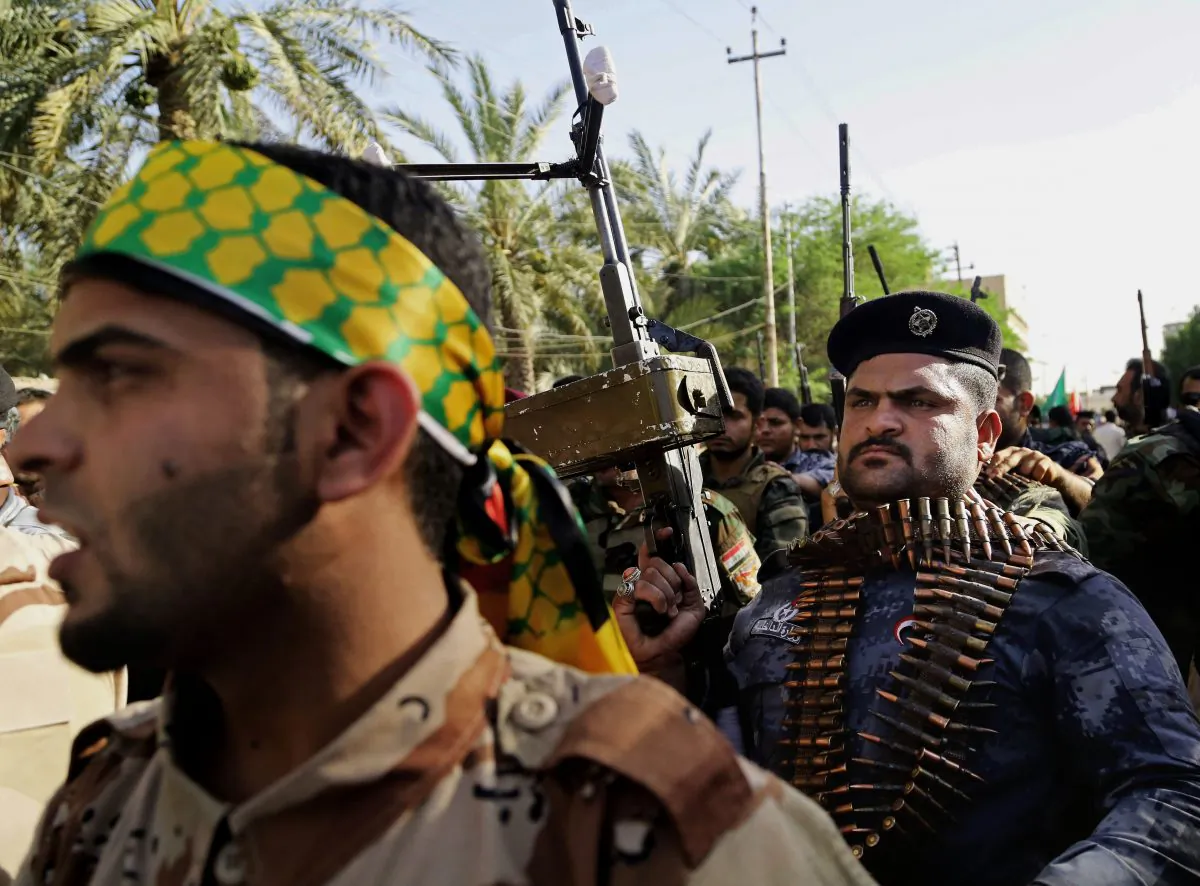 Shiite tribal fighters raise their weapons and chant slogans against the al-Qaida-inspired Islamic State group, in Basra, Iraq's second-largest city, 340 miles (550 kilometers) southeast of Baghdad, Iraq, on June 16, 2014. (AP Photo/Nabil Al-Jurani)