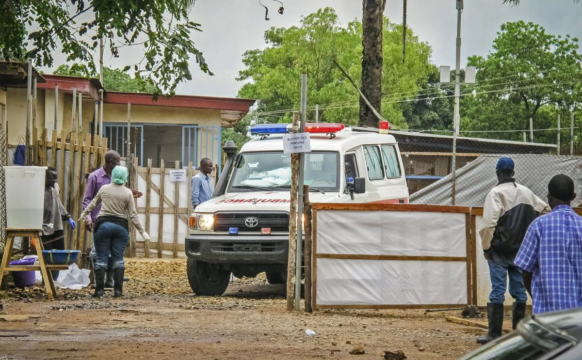 An ambulance leaves the Ebola isolation unit carrying the bodies of Ebola victims that are highly contagious to a burial site, at the Kenema Government Hospital situated in the Eastern Province around 185 miles from the capital city of Freetown in Kenema, Sierra Leone, Aug. 10, 2014. (AP Photo/Michael Duff)