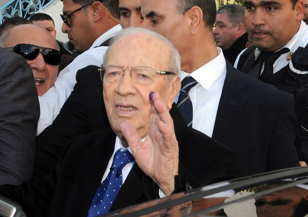 Tunisian presidential candidate, Beji Caid Essebsi, displays his finger with the indelible ink mark after voting in Soukra, on the outskirts of Tunis, Tunisia, Sunday, Dec. 21, 2014. Tunisians must decide Sunday between Beji Caid Essebsi, an 88-year-old veteran of previous regimes, and Moncef Marzouki, a 69-year-old human rights activist who is the outgoing interim president. For the third time in just two months, Tunisian voters will head to the polls this weekend, this time to elect a president in a runoff vote that presents a stark choice between the country's past and its Arab Spring revolution. (AP Photo/Hassene Dridi)