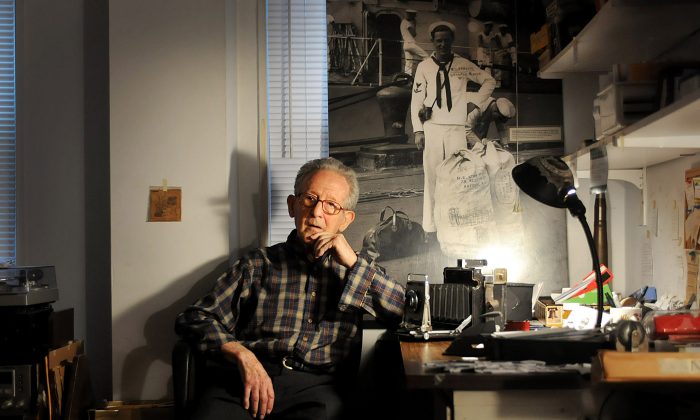 Herman Schnipper, 91, who was a NAVY photographer aboard the USS Astoria during WWII, in Hackensack, N.J., on Dec. 9, 2014. The 1,500 prints—sheathed in plastic, captioned and stored in his Hackensack apartment—depict in black-and-white splendor the drama and drudgery of military service. (AP Photo/Northjersey.com, Mitsu Yasukawa)