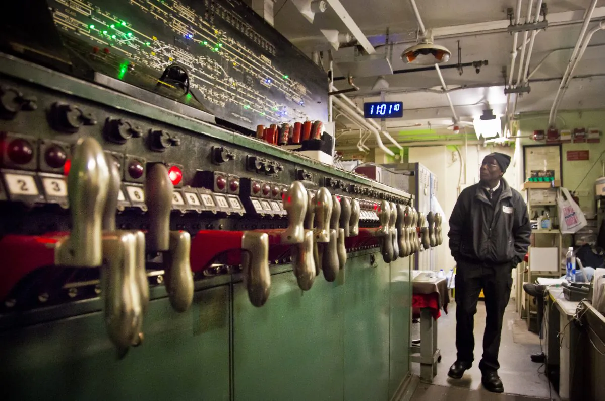 MTA train service supervisor Tweh Friday monitors a subway interlocking switch and signal control board, at the 4th Street MTA Supervisory Tower in New York on Dec. 16, 2014. The 1930s technology of switches and relays requires a human operator to use hand levers to manually route trains and keep them separated at safe distances. (AP Photo/Bebeto Matthews)