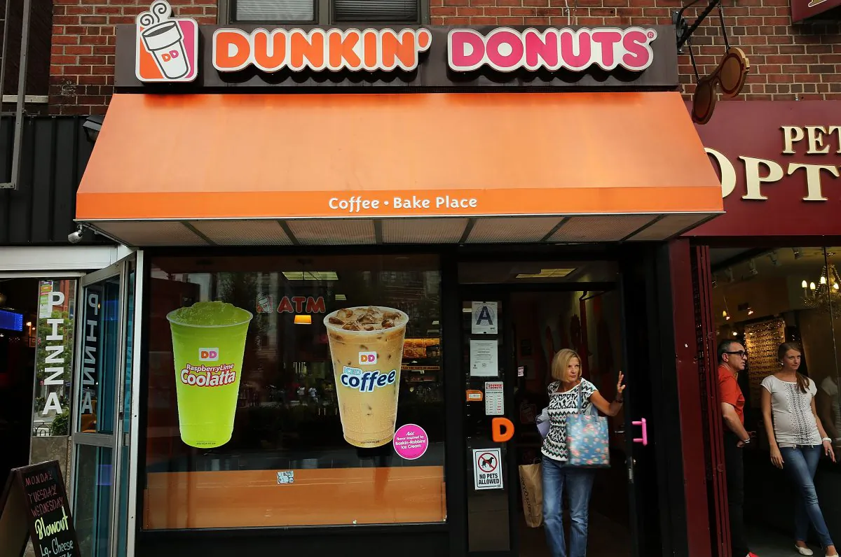 A woman walks out of a Dunkin' Donuts on July 25, 2013, in New York City. (Spencer Platt/Getty Images)