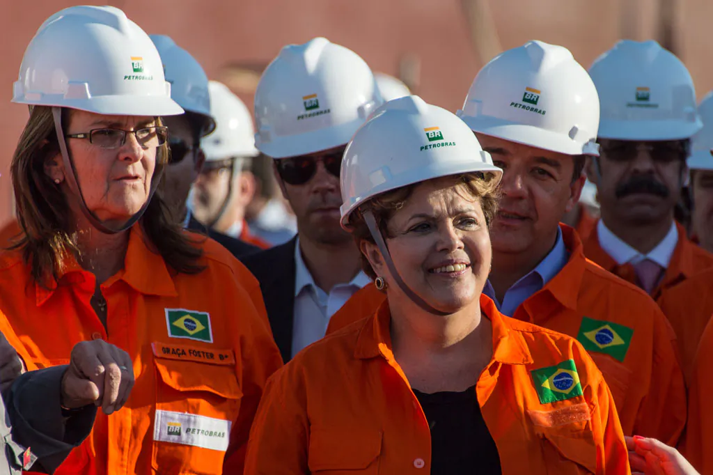Brazilian President Dilma Rousseff (R) walks with Maria das Graças Foster, President of the Brazilian state-run oil giant Petrobras, during a meeting with workers of Petrobras's shipyards in Rio de Janeiro, on Sept. 11, 2013. (Vanderlei Almeida/AFP/Getty Images)