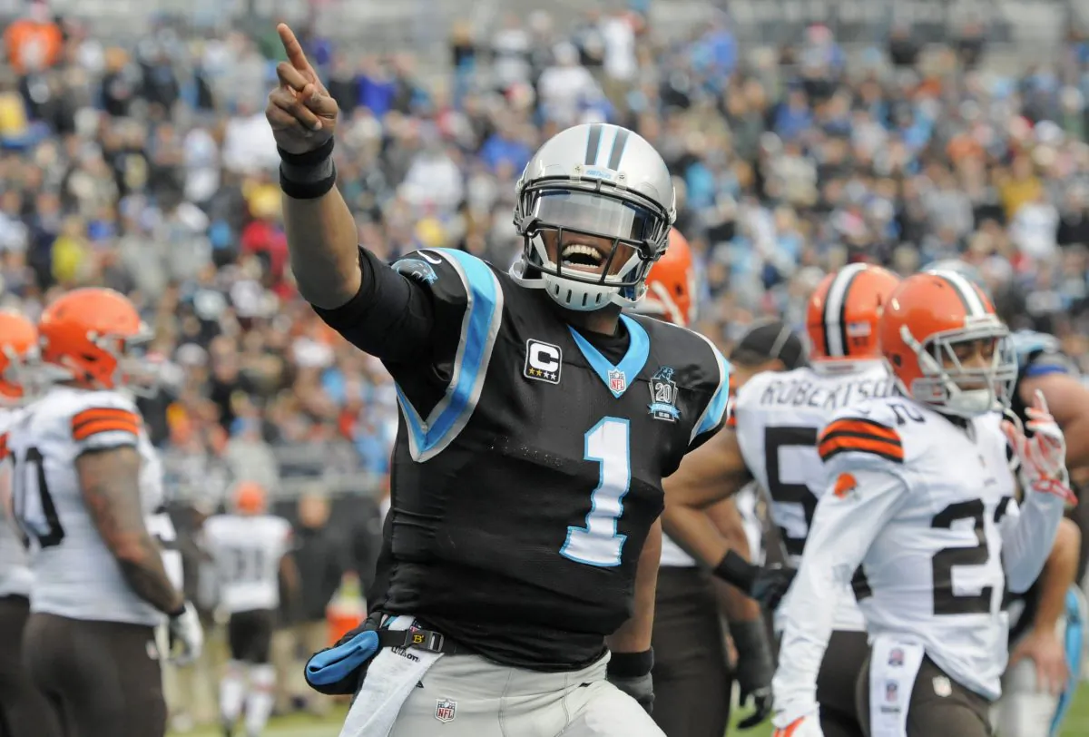 Carolina Panthers' Cam Newton (1) celebrates after running for a touchdown against the Cleveland Browns in the first half of an NFL football game in Charlotte, N.C., Sunday, Dec. 21, 2014. (AP Photo/Mike McCarn)