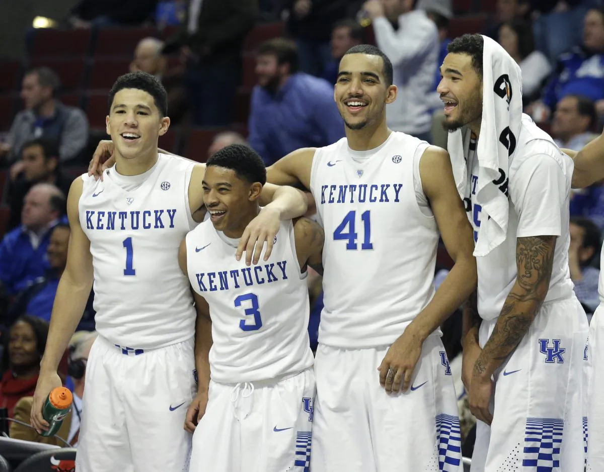 Kentucky players from left, Devin Booker, Tyler Ulis, Trey Lyles, and Willie Cauley-Stein celebrate their 83-42 win over UCLA during the second half of an NCAA college basketball game, Saturday, Dec. 20, 2014, in Chicago. (AP Photo/Nam Y. Huh)