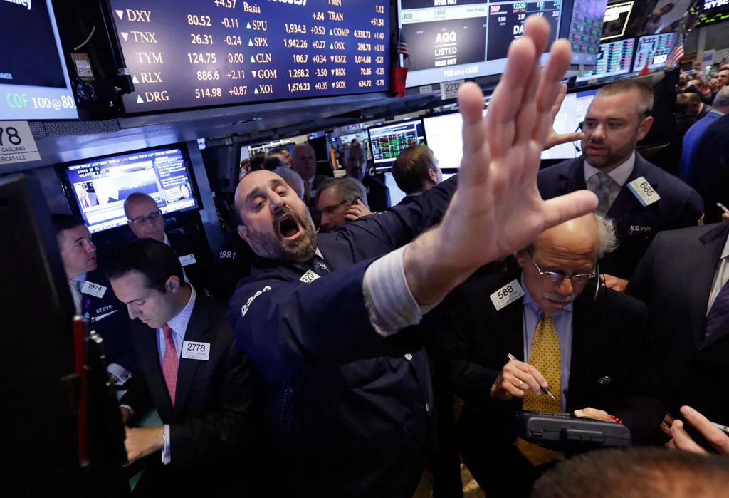 Specialist Peter Giacchi calls out prices during the IPO of Foresight Energy on the floor of the New York Stock Exchange, on June 18, 2014. A strong U.S. economy helped propel the stock market higher for a fifth-straight year in 2014. (AP Photo/Richard Drew)