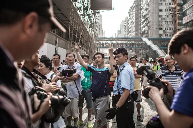 An anti protester gestures towards pro-democracy demonstrators as they protect a barricade in an occupied area of Hong Kong on October 3, 2014. (Philippe Lopez /AFP/Getty Images)