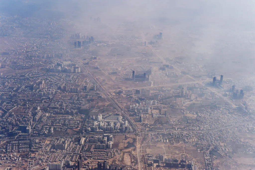 Smog envelops buildings on the outskirts of the Indian capital New Delhi on Nov. 25, 2014. (Roberto Schmidt/AFP/Getty Images)