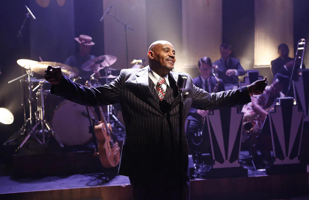 Allan Harris doubles on guitar and vocals, adding his own special quality to “Cafe Society Swing,” now playing at 59 E. 59 Theaters. (Carol Rosegg)