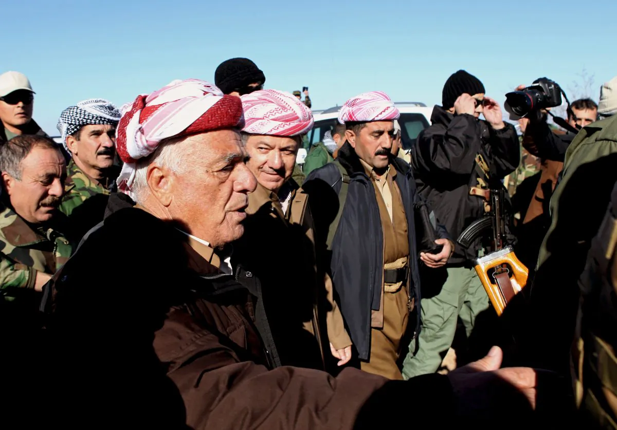 Kurdistan Iraqi regional government President Massoud Barzani (C) arrives to support Kurdish forces as they head to battle Islamic State militants, on the summit of Mount Sinjar, in the town of Sinjar, Iraq, on Dec. 21, 2014. On Sunday, Barazani, visited the command center on the mountain top, vowing to his fighters that they would crush the Islamic State fighters wherever they find them. (AP Photo/Zana Ahmed)
