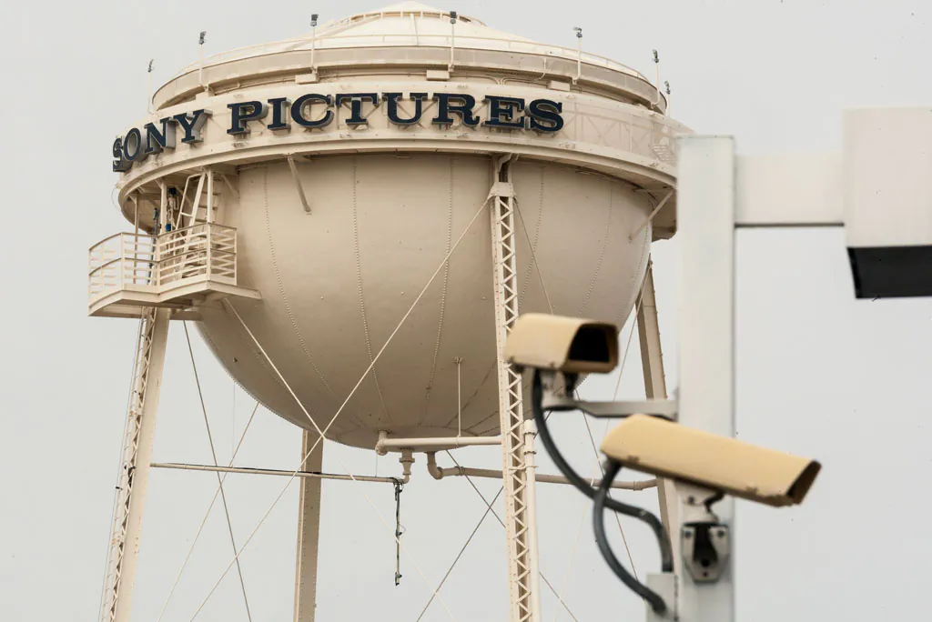 Security cameras stand across the street on Culver Boulevard from the Sony Pictures Studios' water tank in Culver City, Calif., Thursday, Dec. 18, 2014. Sony abruptly canceled the Dec. 25 release of its comedy, "The Interview," which hackers involved in a cyberterrorism campaign against the studio had demanded partly because it included a scene depicting the assassination of North Korea's leader. Sony cited the hackers' threats of violence at movie theaters that planned to show the movie, although the Homeland Security Department said there was no credible intelligence of active plots. (AP Photo/Damian Dovarganes)