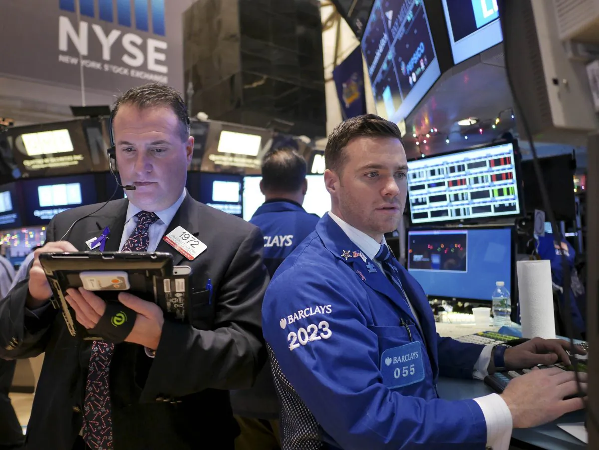 Traders work on the floor at the New York Stock Exchange, Tuesday, Dec. 23, 2014, in New York. U.S. stocks pushed further into record territory on Tuesday as the Dow Jones industrial average crossed past the 18,000-point mark for the first time. (AP Photo/Seth Wenig)