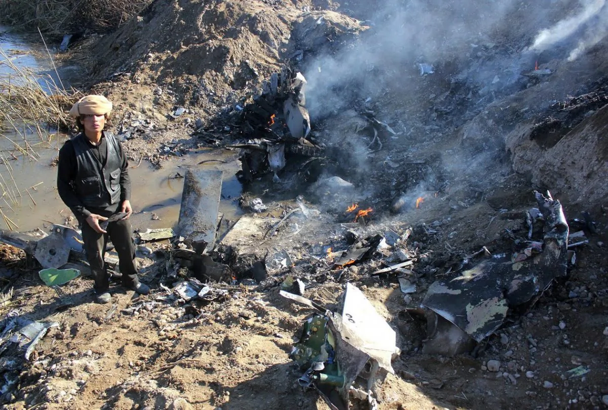 An Islamic State group fighter collecting pieces from the remains of a Jordanian warplane from the US-led coalition after it was shot down in Syria's Raqa region on Dec. 24, 2014. The Islamic State group captured a Jordanian pilot after his warplane from the US-led coalition was reportedly shot down while on a mission against the jihadists over northern Syria. (RMC/STR/AFP/Getty Images)