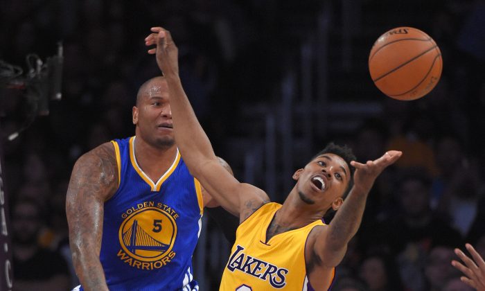 Los Angeles Lakers forward Nick Young, reaches for rebound as Golden State Warriors forward Marreese Speights looks on during the first half of an NBA basketball game, Tuesday, Dec. 23, 2014, in Los Angeles. (AP Photo/Mark J. Terrill)