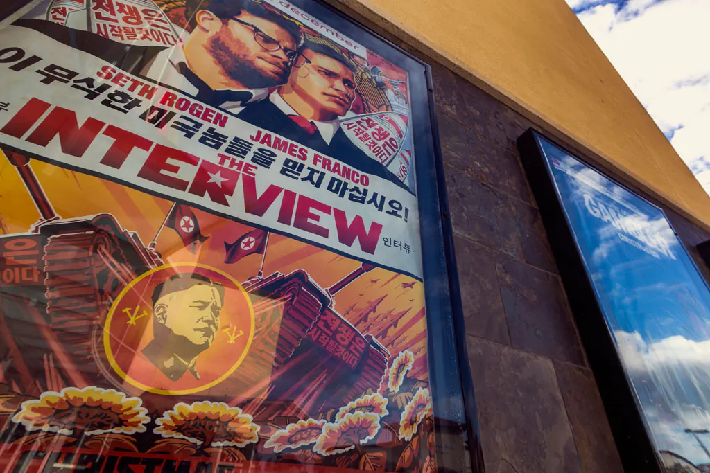 A movie poster for "The Interview" on display outside the AMC Glendora 12 movie theater, in Glendora, Calif., on Dec. 17, 2014. In an unprecedented move, Sony Pictures broadly released "The Interview" to digital platforms on Wednesday. (AP Photo/Damian Dovarganes)