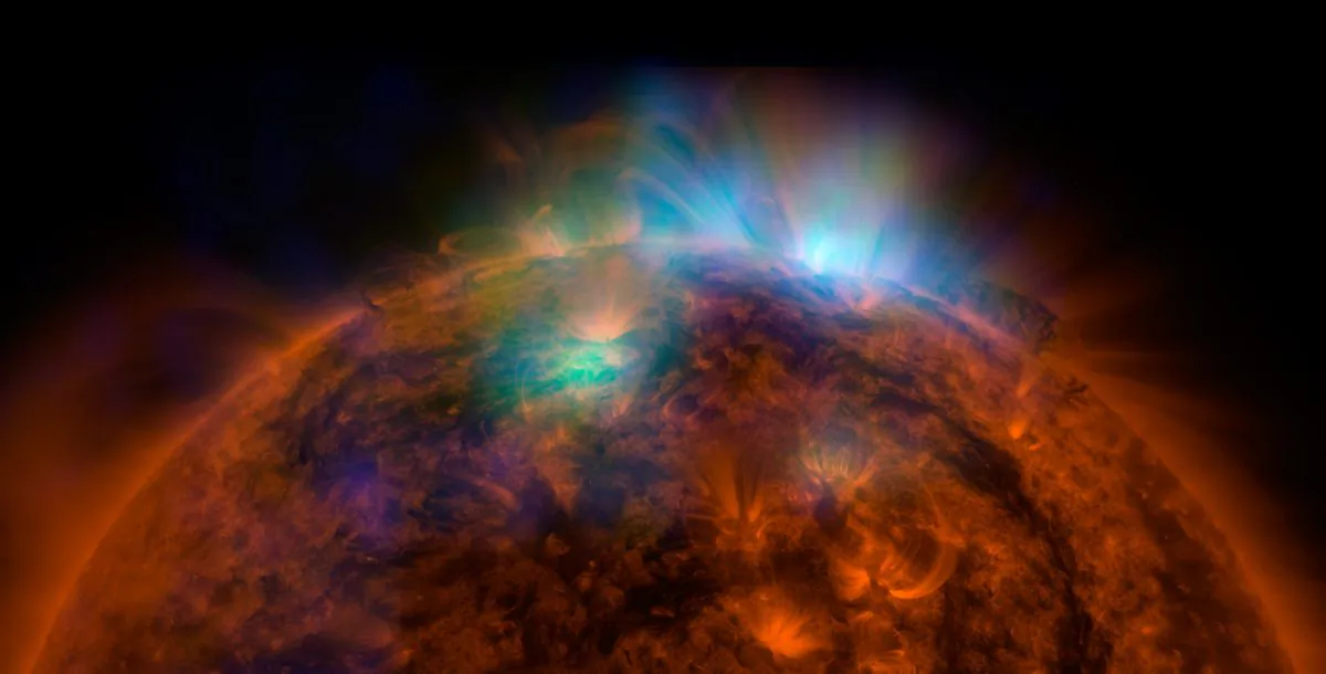 X-rays stream off the sun in this image showing observations by NASA's Nuclear Spectroscopic Telescope Array, or NuSTAR, overlaid on a picture taken by NASA's Solar Dynamics Observatory (SDO). (NASA/JPL-Caltech/GSFC)