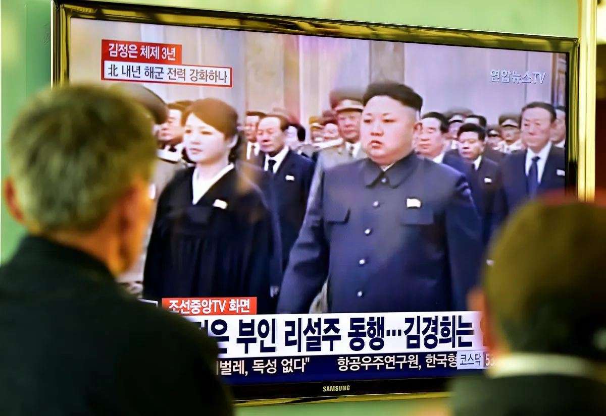 People at a railway station in Seoul watch TV footage showing North Korean leader Kim Jong Un on Dec. 17, 2014. (Jung Yeon-Je/AFP/Getty Images)