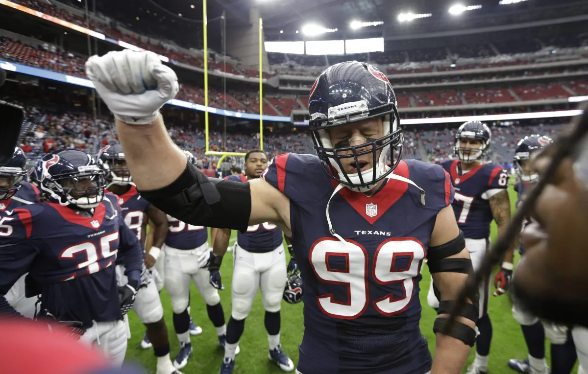 Houston Texans defensive end J.J. Watt (99) cheers in the huddle before an NFL football game against the Baltimore Ravens Sunday, Dec. 21, 2014, in Houston. (AP Photo/David J. Phillip)