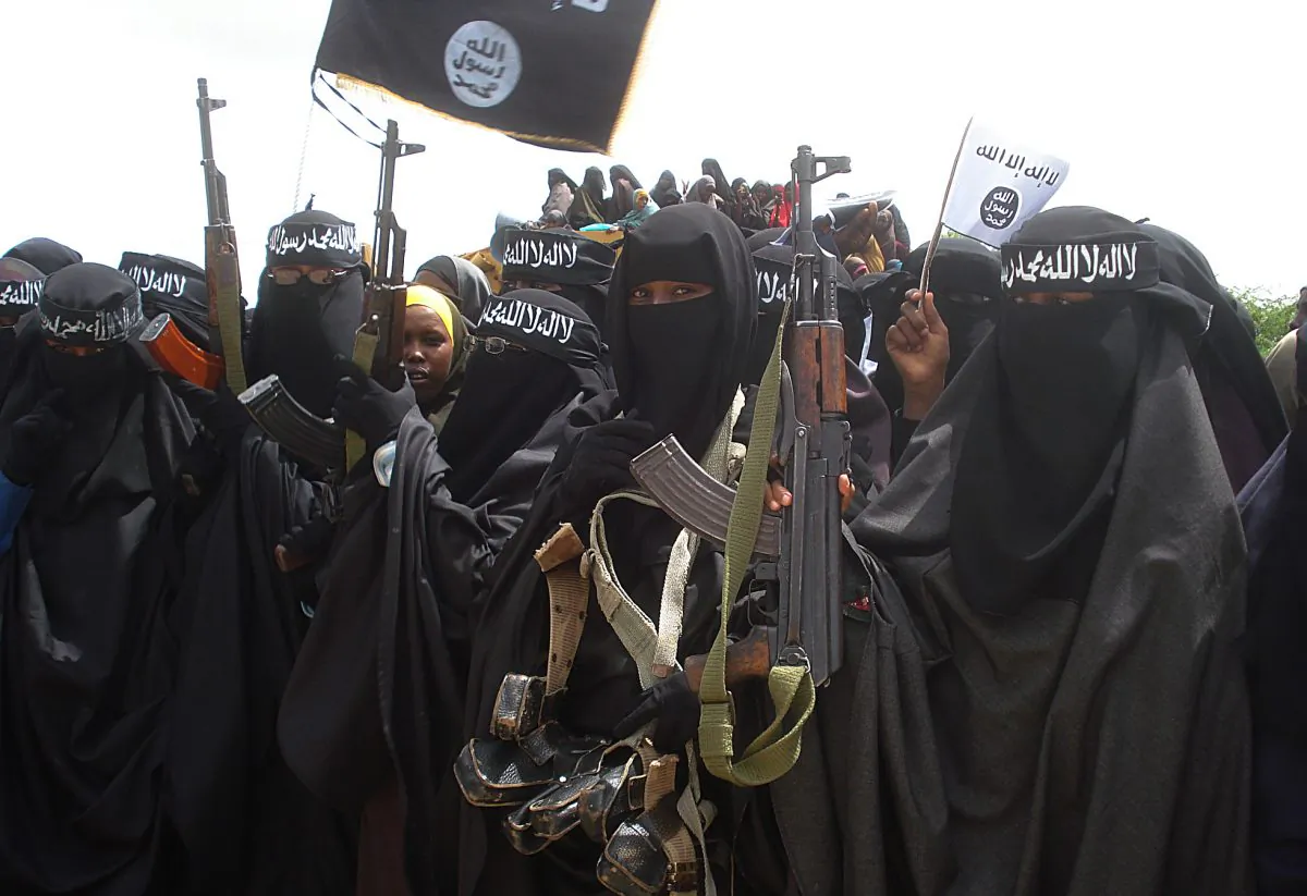 Somali women carry weapons during a demonstration organized by the Extremist group, Al-Shabaab, which is fighting the Somali government in Suqa Holaha neighborhood of Mogadishu on July 5, 2010. (ABDURASHID ABIKAR/AFP/File Photo via Getty Images)