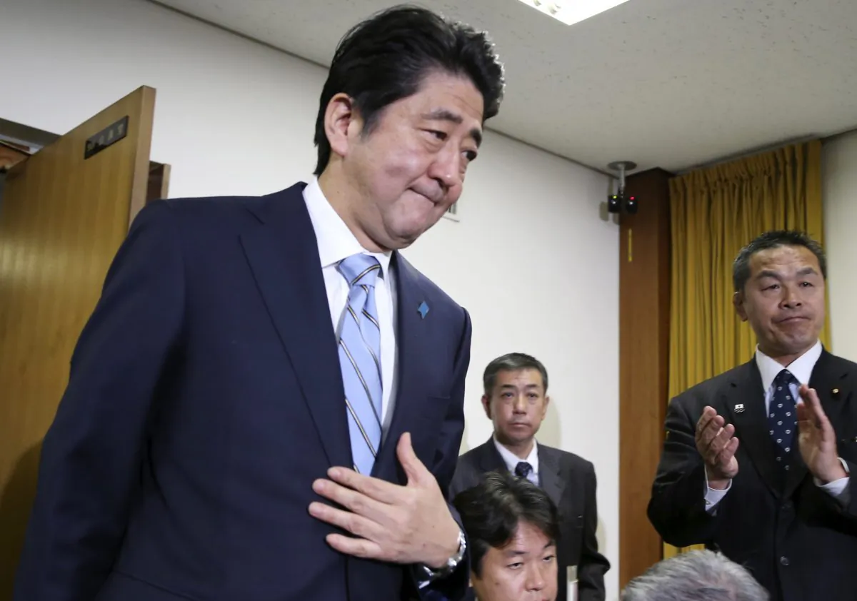 Japanese Prime Minister and leader of the ruling Liberal Democratic Party Shinzo Abe (L) arrives for a press conference at the party headquarters in Tokyo on Dec. 15, 2014. Japan's Cabinet on Saturday, Dec. 27, 2014, approved about 3.5 trillion yen ($29 billion) in fresh stimulus, including subsidies and job creation, to help pull the world's third-largest economy out of recession. (AP Photo/Koji Sasahara)