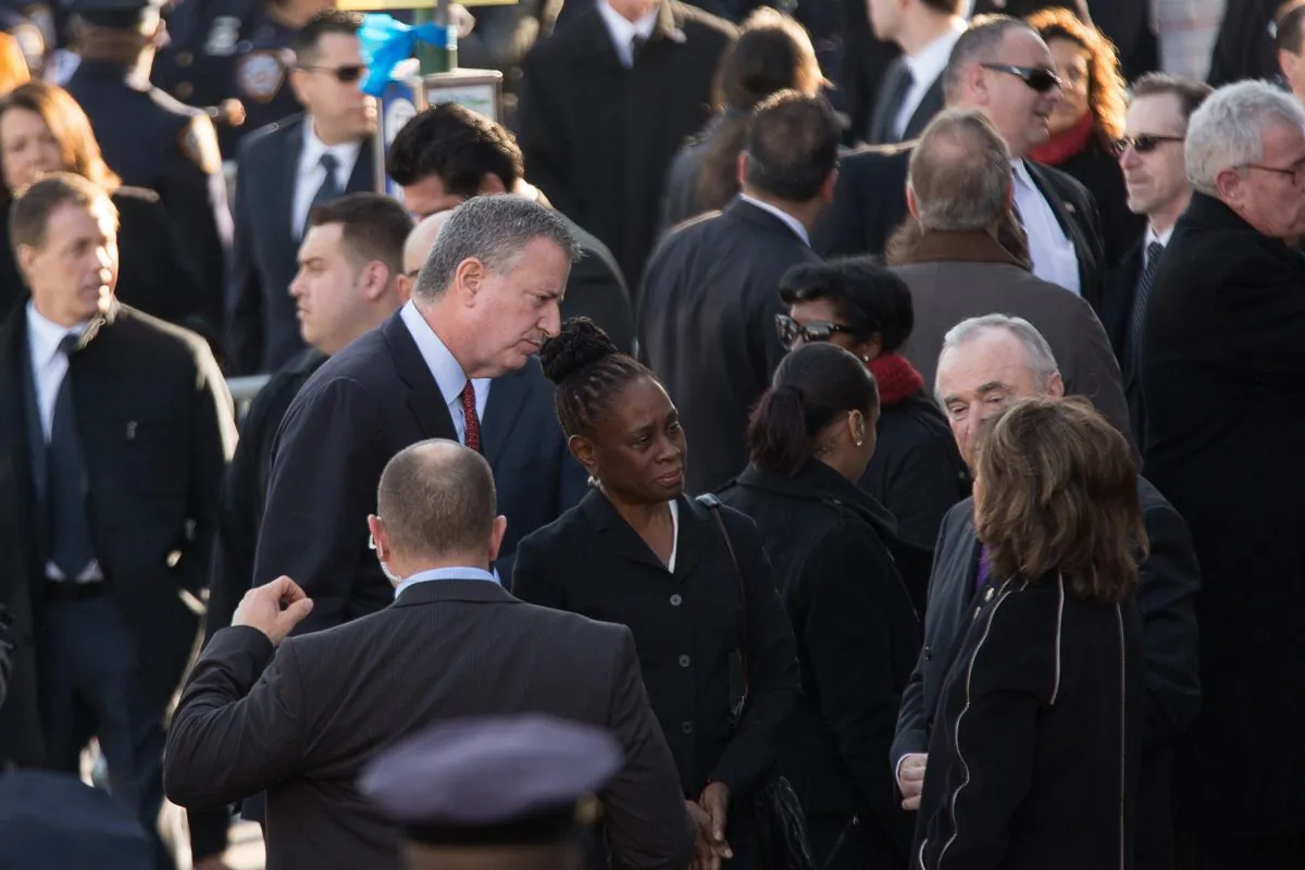 (L-R) New York Mayor Bill de Blasio, with his wife Chirlane McCray, greet Police Commissioner Bill Bratton and his wife Rikki Klieman outside the funeral of slain New York Police Department (NYPD) officer Rafael Ramos at the Christ Tabernacle Church in New York City on Dec. 27, 2014. (Kevin Hagen/Getty Images)