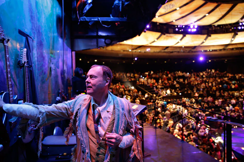 Bruce Rickerd hangs up his guitar after a performance of the show "Mystere" in Las Vegas on Dec. 17, 2014. On Saturday, Dec. 27, 2014, a Guinness Book of World Records judge is expected to say Rickerd has broken the record from most theatrical performances by a male musician. (AP Photo/John Locher)