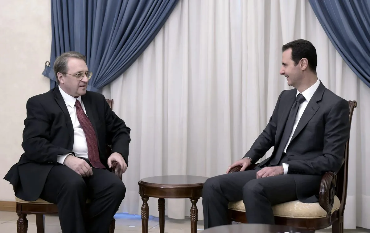 Syrian President Bashar Assad, right, meets with Russia's deputy Foreign Minister Mikhail Bogdanov in Damascus, Syria, Wednesday, Dec. 10, 2014. (AP Photo/SANA)