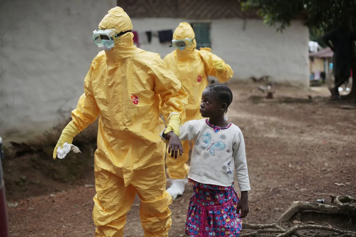 This Sept. 30, 2014 file photo shows Nowa Paye, 9, as she is taken to an ambulance after showing signs of Ebola infection in the village of Freeman Reserve, about 30 miles north of Monrovia, Liberia. (AP Photo/Jerome Delay)