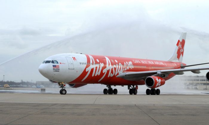 Malaysia's long-haul budget airline AirAsia X Airbus A340 jetliner is greeted with jets of water upon its landing at the end of the AirAsia X first flight Kuala-Lumpur-Paris at Paris' Orly airport on Feb. 14, 2011. AirAsia X is a branch of largest low-cost carrier AirAsia. (Eric Piermont/AFP/Getty Images)