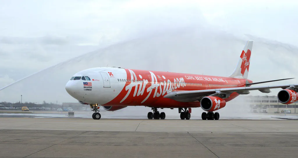 Malaysia's long-haul budget airline AirAsia X Airbus A340 jetliner is greeted with jets of water upon its landing at the end of the AirAsia X first flight Kuala-Lumpur-Paris at Paris' Orly airport on Feb. 14, 2011. AirAsia X is a branch of largest low-cost carrier AirAsia. (Eric Piermont/AFP/Getty Images)