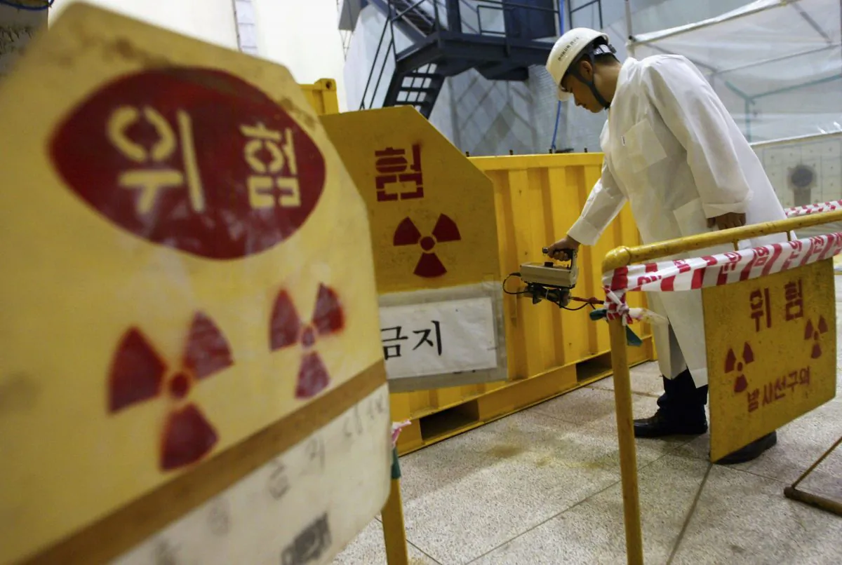 A South Korean nuclear scientist tests a partly dismantled experimental reactor for radiation in part of at a Korea Atomic Energy Research Institute  in Seoul, South Korea, on Sept. 10, 2004. (Chung Sung-Jun/Getty Images)