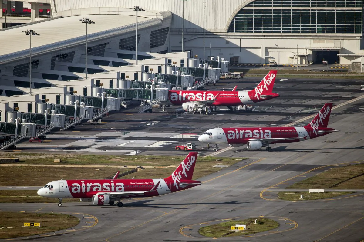 In this Nov 26, 2014 photo, AirAsia Airbus A320-200 passenger jets are parked on the tarmac at low cost terminal KLIA2 in Sepang, Malaysia. An AirAsia plane with 161 people on board lost contact with ground control on Sunday, Dec. 28, 2014, while flying over the Java Sea after taking off from a provincial city in Indonesia for Singapore, and search and rescue operations were underway. The planes in this photo are not the plane that went missing while flying from Indonesia to Singapore but one of the same models. (AP Photo/Vincent Thian)