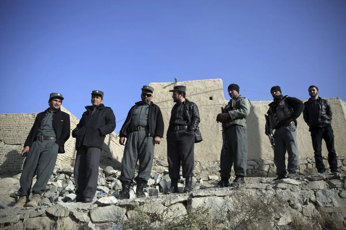 Afghanistan's police officers stand near the site of a suicide attack in Kabul, Afghanistan, on Dec. 11, 2014. (AP Photo/Massoud Hossaini)