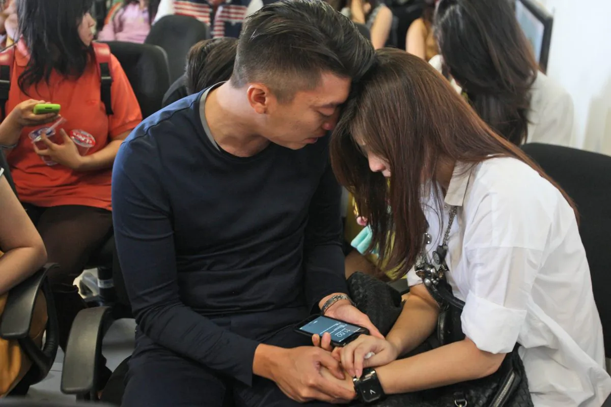  Relatives of the passengers of AirAsia flight QZ8501 comfort each other at Juanda International Airport in Surabaya, East Java, Indonesia, Sunday, Dec. 28, 2014. (AP Photo/Trisnadi)