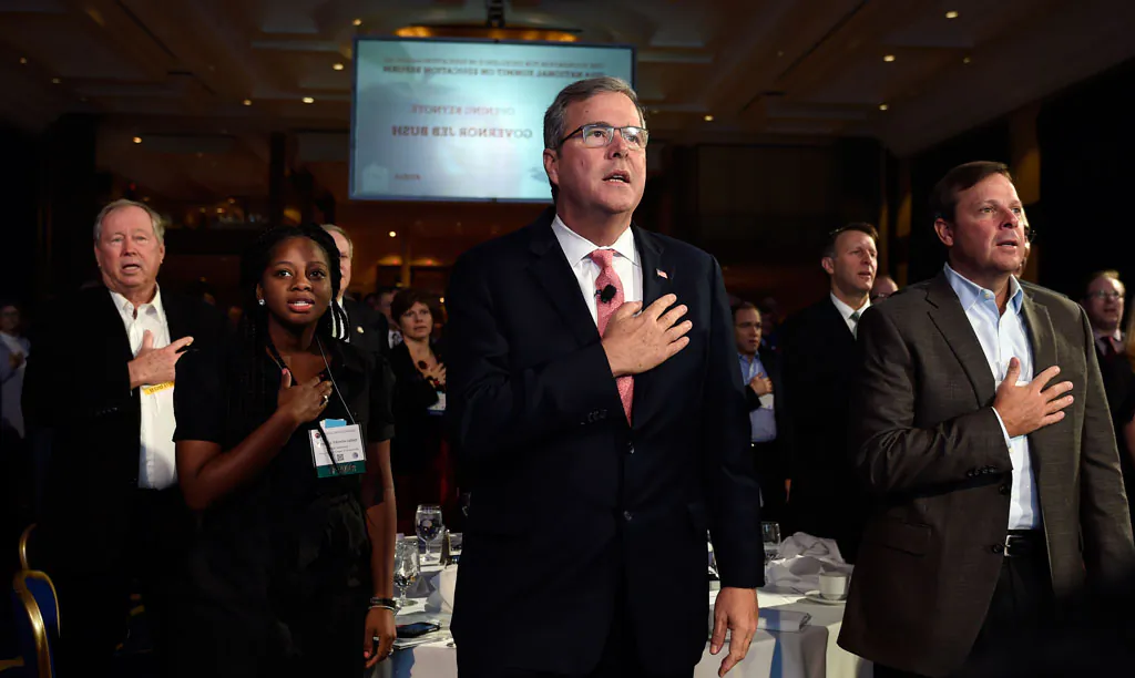 Former Florida Gov. Jeb Bush (C) recites the Pledge of Allegiance before giving the keynote address at the National Summit on Education Reform in Washington on Nov. 20, 2014. Denisha Merriweather (2L), who benefited from the Florida tax credit for education, introduced Bush. The faces of the Republican Party’s most ambitious members are changing. Long criticized as the party of old, white, men, the GOP’s next class of presidential contenders may include two Hispanic senators, an Indian-American governor, a female business leader and an African-American neurosurgeon. Among perhaps a dozen GOP White House hopefuls, all but a few are in their 40s and 50s. One of the oldest white men, Jeb Bush, is a fluent Spanish speaker whose wife is a native Mexican. Republicans say they’re starting the 2016 presidential and congressional elections from a strong place after winning control of Congress a few weeks ago. But Democrats say that’s misleading; the midterm electorate was older and whiter than in presidential elections. (AP Photo/Susan Walsh)