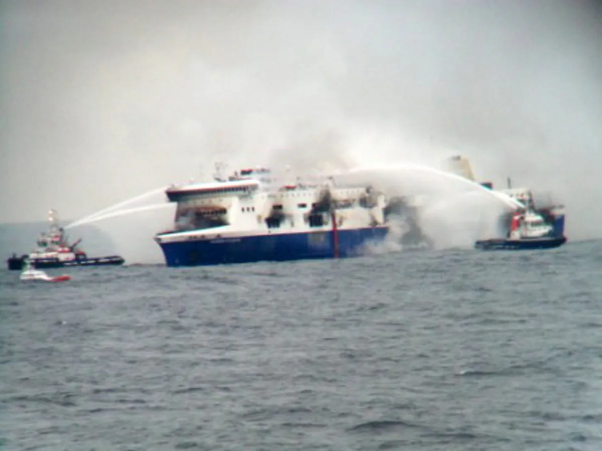 In this photo taken from a nearby ship, vessels try to extinguish the fire at the Italian-flagged Norman Atlantic after it caught fire in the Adriatic Sea, Sunday, Dec. 28, 2014. Italian and Greek military and coast guard rescue crews battled gale-force winds and massive waves Sunday as they struggled to rescue hundreds of people trapped on a burning ferry adrift between Italy and Albania. At least one person died and two were injured. The Italian Defense Ministry said 165 of the 478 people on the ferry had been evacuated by Sunday evening, more than 14 hours after the fire erupted. (AP Photo/SKAI TV Station)