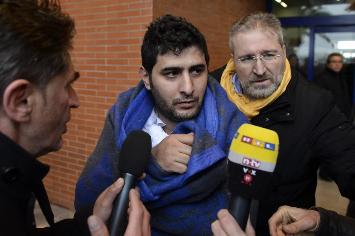 A journalist interviews a passenger of the Italian-flagged Norman Atlantic, that caught fire in the Adriatic Sea, in the harbor of Bari, southern Italy, Monday, Dec. 29, 2014. A ferry carrying nearly 500 people caught fire off the Greek island of Corfu early Sunday, trapping passengers on the top decks as gale-force winds and choppy seas hampered the evacuation. Greek and Italian rescue helicopters and vessels struggled to reach the stricken ferry, with nearby merchant ships lining up to form a wall against the raging gusts. (AP Photo/Luigi Mistrulli)