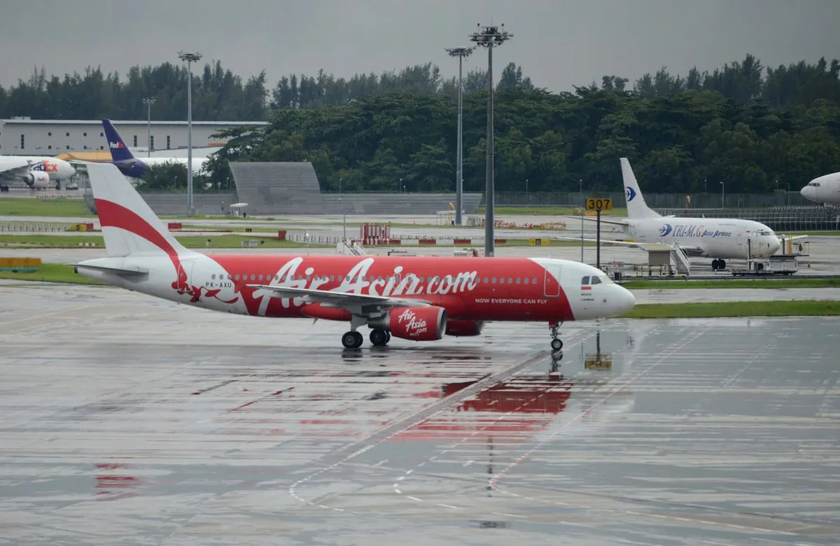 An AirAsia flight taxis on the tarmac after landing at at Changi international airport in Singapore on Dec. 29, 2014. A Chinese blogger warned almost two weeks before AirAsia flight QZ8501 went missing on Dec. 28 that disaster would strike Malaysian aielines, including AirAsia. (Mohd Fyrol/AFP/Getty Images)