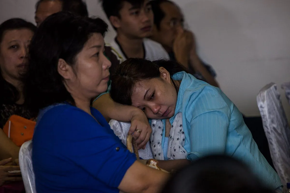 Family members of AirAsia QZ8501 passengers wait for news at the crisis center at Juanda international airport in Surabaya, Indonesia, on Dec. 29, 2014. (Oscar Siagian/Getty Images)